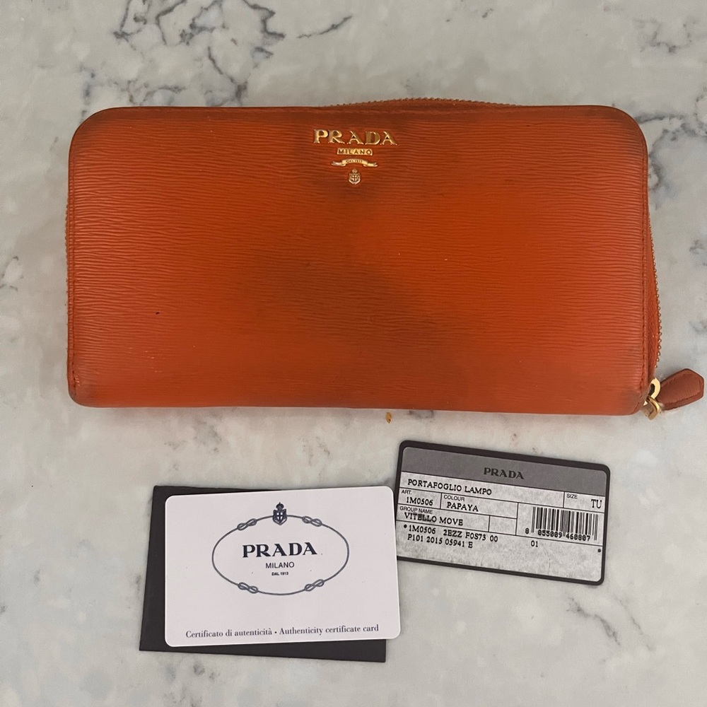 Prada Vitello Move Wallet in Papaya with gold wrap around zipper and gold logo